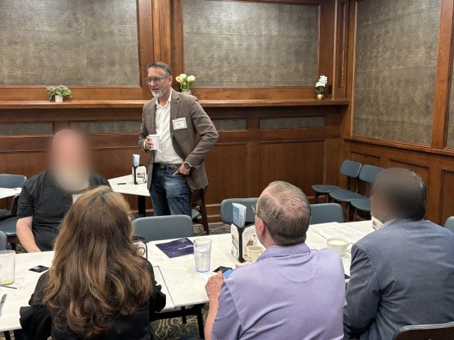 Abhi talking with CIOs around breakfast tables